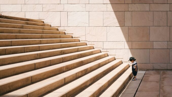 Kid facing the challenge of large stairs illustrating the diminishing returns that OpenAI is reportedly facing with the training and development of its latest AI model.